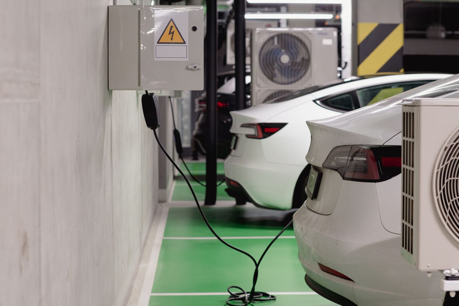 Electric cars charging at workplace car park charge points, UK